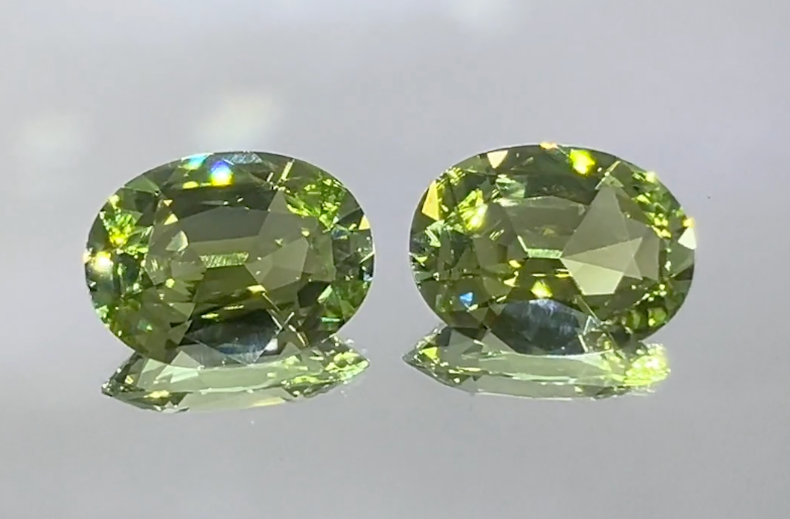 16.32ct Unheated Flawless Racing Green Paraiba Earrings with D Flawless Diamonds set in 18K Yellow Gold